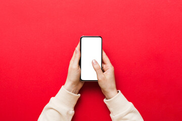 Top view of woman hands holding smart phone with blank copy space screen for your text message or information content. woman hand using phone white screen on top view - Powered by Adobe