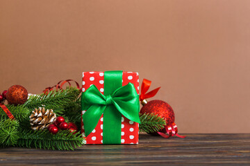 New Year Christmas mood, gift box, branches of a christmas tree, New Year decorations on a colored background