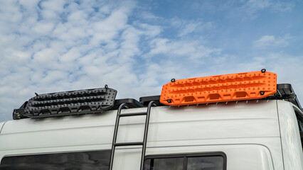 detail of 4x4 camper van with a ladder, roof racks and recovery ladders