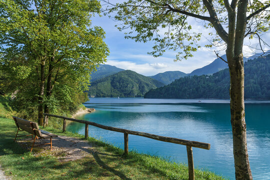 Alpine Lake Ledro (Lago di Ledro) in Trentino, northern Italy. Lake in the mountains. Bench on the shore for relaxation and contemplation.