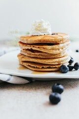 Vertical shot of Blueberry Pancakes with Whipped Cream