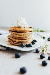 Vertical shot of Blueberry Pancakes with Whipped Cream