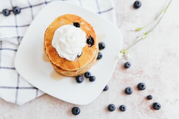 Closeup shot of Blueberry Pancakes with Whipped Cream