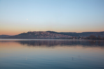 View houses by the lake, city. sunset lake view. orange sky and moon. Sapanca lake in the evening.