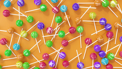 Colorful and flavored big shiny lollipops on orange pastel background flat lay top view