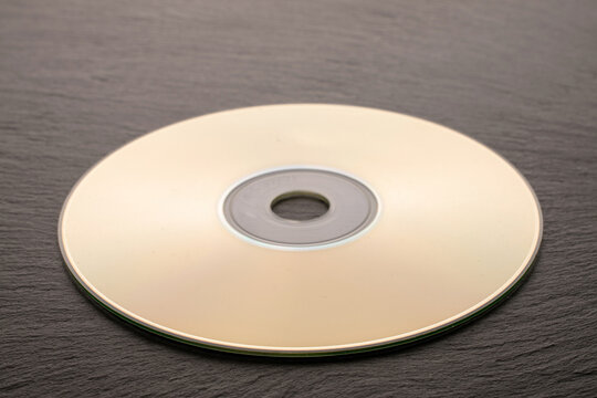 One CD-R disc on slate stone, macro.