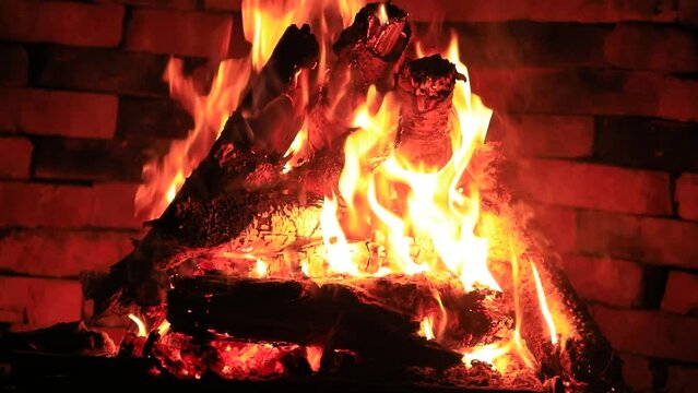 Firewood is burning in the fireplace