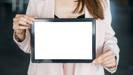 Digital mockup. Online technology. Advertising background. Unrecognizable woman holding tablet computer blank screen in light room interior.