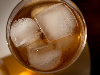Iced tea in a glass with ice cubes. Cold tea with ice.