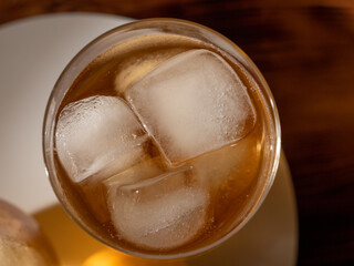 Iced tea in a glass with ice cubes. Cold tea with ice.