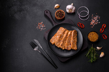Tasty meat brawn or roll on a wooden cutting board with spices and herbs