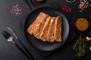 Tasty meat brawn or roll on a wooden cutting board with spices and herbs