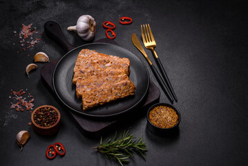Tasty meat brawn or roll on a wooden cutting board with spices and herbs