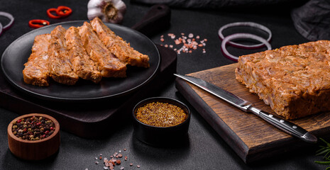 Tasty meat brawn or roll on a wooden cutting board with spices and herbs