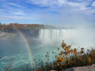 Mesmerizing shot of Niagara Falls with a small rainbow on the US and Canada border