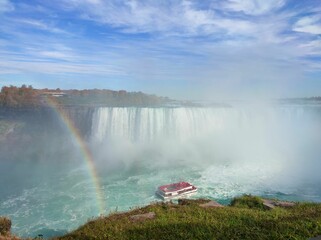 Mesmerizing shot of Niagara Falls with a small rainbow on the US and Canada border