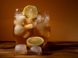 Iced tea in a glass with ice cubes. Cold tea with ice.