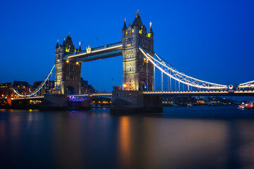 Long exposure, illuminated Tower Bridge over river Thames in London