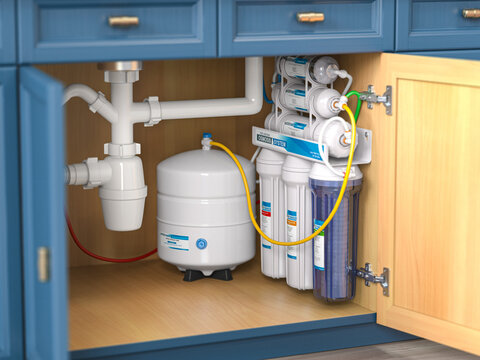 Reverse osmosis water purification system under sink in a kitchaen.  Water cleaning system installation.