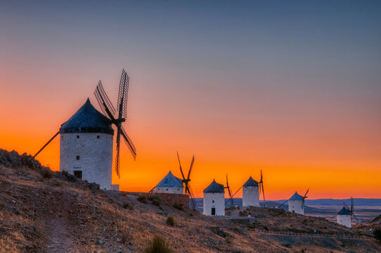 Consuegra windmills at sunset in the province of Toledo, Spain