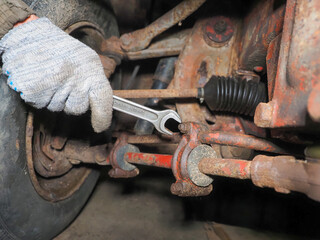 Mechanic is repairing car suspension