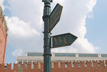 Text on the signpost: Luggage room. WC and Luggage room signs on the signpost in the Alexander...