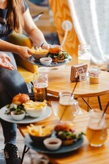 Vertical shot of a gourmet fast food restaurant table with burgers, fries, and drinks