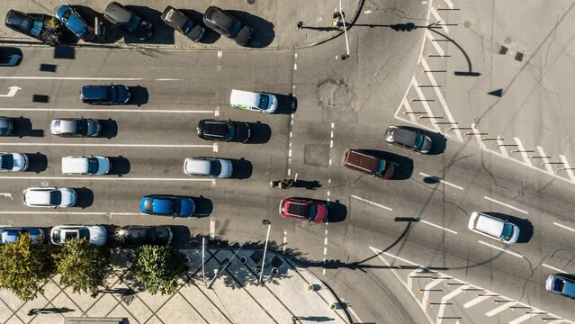 Slow turning shot above of road with moving cars.