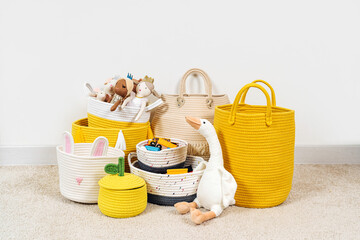 Colorful Toy Storage Baskets in the children's room. Cloth stylish Baskets different sizes with...