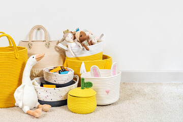 Colorful Toy Storage Baskets in the children's room. Cloth stylish Baskets different sizes with...