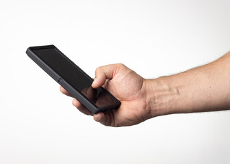 Hand and arm of a man holding a cell phone on a nuclear white background.