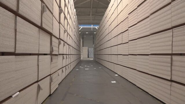mdf boards and chipboards storing at factory, production, manufacture and woodworking industry concept - chipboards processing.