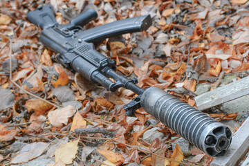 A Kalashnikov assault rifle is lying on the ground.