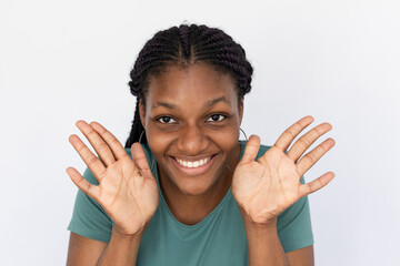 Smiling woman showing open palms. Young female model in turquoise T-shirt holding open palms at...