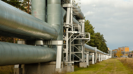 pipeline, in the photo the pipeline is close-up, in the background the city and buildings