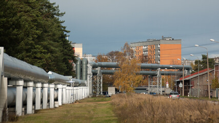 Fototapeta na wymiar pipeline, in the photo the pipeline is close-up, in the background the city and buildings