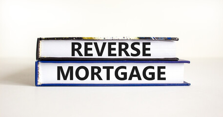 Reverse mortgage symbol. Concept words Reverse mortgage on books. Beautiful white table white background. Business and reverse mortgage concept. Copy space.