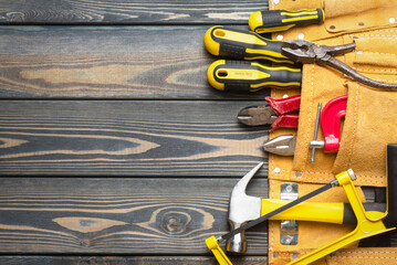 Construction tools in bag on the carpenter workbench flat lay background with copy space.