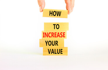 Increase your value symbol. Concept words How to increase your value on wooden blocks. Businessman hand. Beautiful white background. Business how to increase your value concept. Copy space.