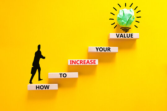 Increase your value symbol. Concept words How to increase your value on wooden blocks. Businessman icon. Beautiful yellow background. Business how to increase your value concept. Copy space.