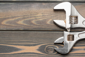 Adjustable wrench on the workbench table flat lay background with copy space.