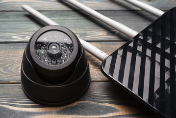 Security camera and wifi router on the table background close up. Video surveillance concept...