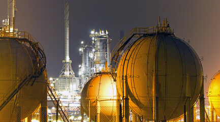 A large oil-refinery plant with Liquefied Natural Gas - LNG - storage tanks - 545757910