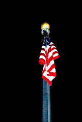 American flag at night high in the sky outdoors.