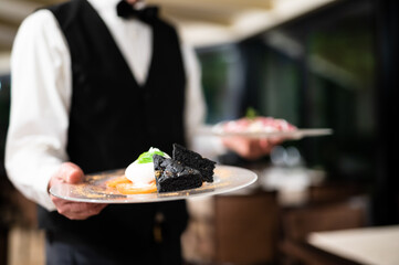 Waiter holdingdishes ready to be served