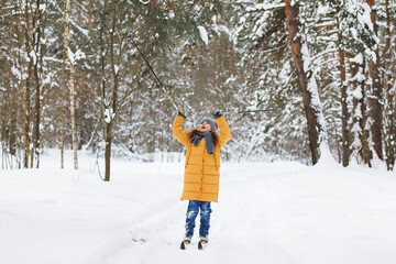 Fototapeta na wymiar Girl skiing in the forest