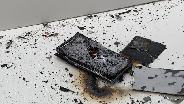 Broken phone. Hammer hitting the display breaks the mobile phone. Mobile smartphone with a broken screen. Drop Test. Hammer Durability. Hammer vs mobile display. Smashing the Phone. Breaking display.