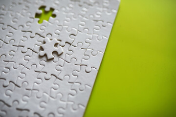 Clean puzzle elements on the background. Empty puzzle piece on the table. Teamwork concept.
