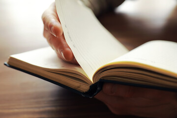 Reading religious literature. Open book. Man reads bible or Koran.