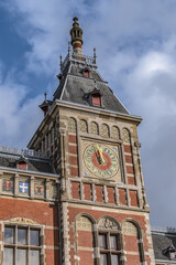 Obraz premium Architectural fragments of historic building of Amsterdam central railway station (opened in 1889). Amsterdam, the Netherlands.
